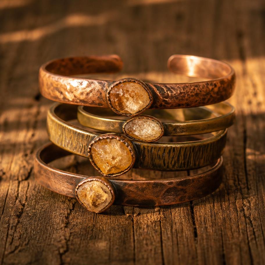 Stack of copper and brass cuff bracelets set with raw citrine stones